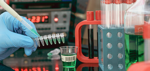 Sample preparation for Mass spectrometry in a scientific laboratory. Filling test tubes with...