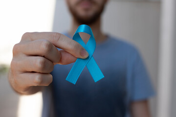Blue november. Prostate Cancer Prevention Month. man holding blue ribbon. Men's health blue march,...