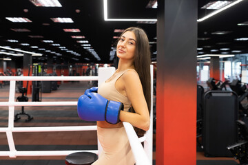 Beautiful fitness woman in the boxing ring