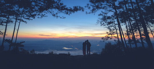 Silhouette couple with a beautifu mountain ridge and sky
