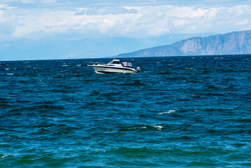 boat floating on the water against the background of mountains