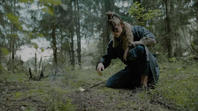 Wizard finishes ritual and extinguishes bonfire in wood