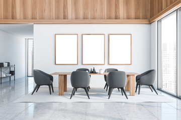 Three empty wood frames on white dining room wall