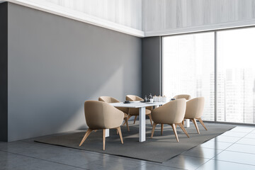 Corner of grey panoramic dining room with beige chairs