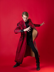 An outrageous young man in a daring red coat in a vintage noir style, - obrazy, fototapety, plakaty