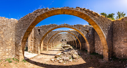 Ruins of abandoned olive oil production factory in Agios Georgios monastery, Vamos, Crete, Greece. - obrazy, fototapety, plakaty