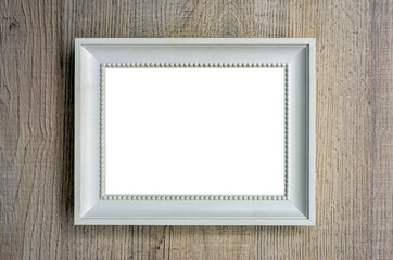 blank white picture frame on wood wall or table