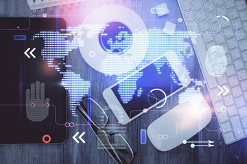 Double exposure of map hologram drawing over desktop. Top view. International connection concept.