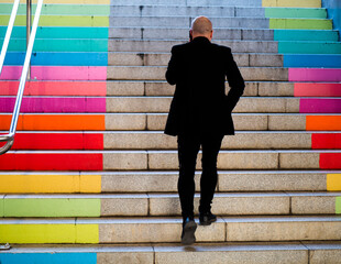 businessman talking on phone and climbing stairs