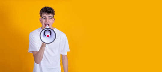 teenager boy with megaphone yelling isolated on background
