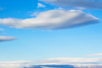 Naklejka na ściany i meble fluffy clouds on a blue sky. beautiful nature background in spring