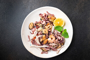 seafood mix shrimp, squid, mussel, rapan, octopus fresh portion ready to eat meal snack on the table copy space food background rustic. top view keto or paleo diet vegetarian food pescetarian diet