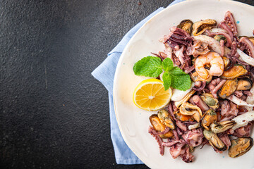seafood mix shrimp, squid, mussel, rapan, octopus fresh portion ready to eat meal snack on the table copy space food background rustic. top view keto or paleo diet vegetarian food pescetarian diet