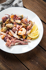seafood mix shrimp, squid, mussel, rapan, octopus fresh portion ready to eat meal snack on the table copy space food background rustic. top view keto or paleo diet vegetarian food pescetarian diet