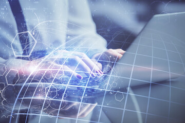 Double exposure of woman hands working on computer and world map hologram drawing. International technology business concept.
