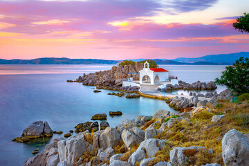 Little church of Agios Isidoros in the sea over the rocks, Chios island, Greece. - 460594577