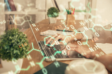 Double exposure of woman hands typing on computer and formula hologram drawing. Education concept.