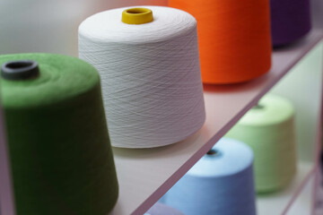 large group of bobbin thread cones on the shelf