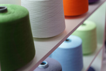 large group of bobbin thread cones on the shelf