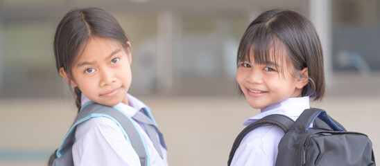 Portrait of children student in uniform and backpack Looking at camera going back to school after covid-19 quarantine and lockdown. Back to School Concept Stock Photo