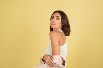 Obraz premium Indoor studio portrait of woman on yellow background happy positive moving cheerful