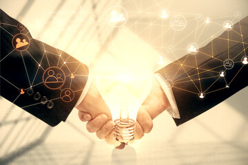 Double exposure of social network theme hologram and handshake of two men.