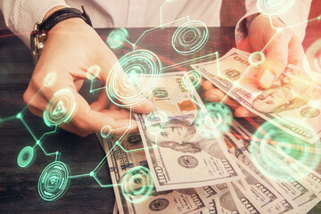 Multi exposure of social network theme drawing hologram and USA dollars bills and man hands.