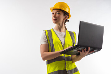 An architect in white uniform. Architect builder with laptop in his hands. Architect in yellow uniform. Girl in construction uniform. Portrait of woman engineer. Concept - construction software