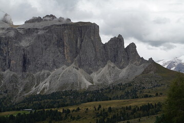 Mountain valley with beautiful house and church at sunset in autumn. Landscape with buildings, high rocks, colorful sky, clouds, sunlight. Mountains in Tre Cime park in Dolomites, Italy. Italian Alps
