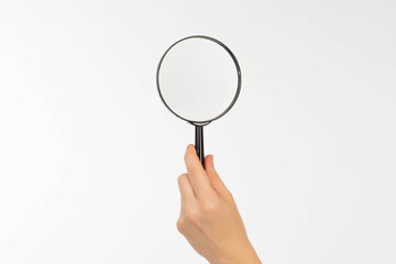 Hand with a magnifying glass. Magnifying glass as a symbol of search. Information search concept with magnifying glass. Loupe on a white background. Increase something with magnifier.