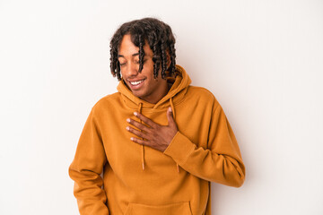 Fototapeta na wymiar Young african american man isolated on white background laughing keeping hands on heart, concept of happiness.
