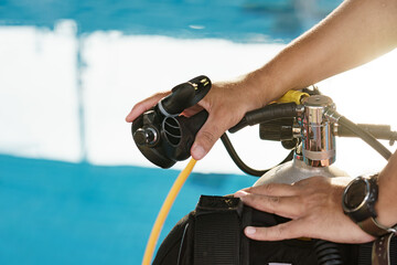 Male hands checking diving equipment before Dive.