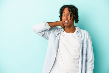 Young african american man isolated on blue background touching back of head, thinking and making a choice.