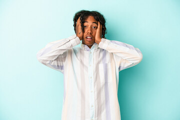 Young african american man isolated on blue background being shocked, she has remembered important...