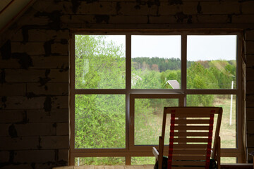 The wooden chair inside house view from window