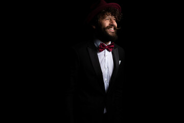 sexy businessman smiling wide and wearing a burgundy hat