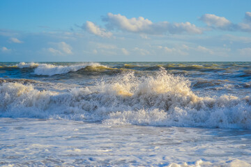 Small storm at sunset, high waves with white foam © Delia_Suvari