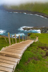 Fototapeta na wymiar Steep stairs at the beginning of the cliff hike in Gjógv (gorge, geo), Eysturoy island, Faroe Islands.