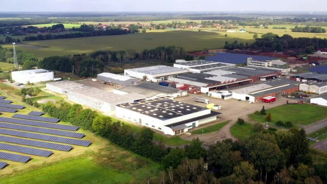 Aerial view of a business park nit flat production halls and warehouses in an agricultural environment in Lower Saxony, Germany