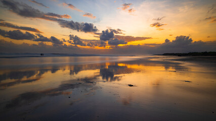 Sunset time. Seascape background. Cloudy sky. Scenic view. Sunset golden hour. Sunlight reflection in water. Magnificent scenery. Magnificent scenery. Copy space. Kelanting beach, Bali