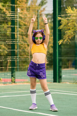Schoolgirl preteen resting on sports ground