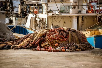 boat nets piled up to dry at the fishing port