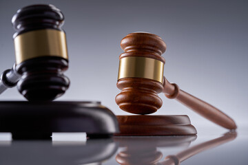 close up of gavel hammer on gray background
