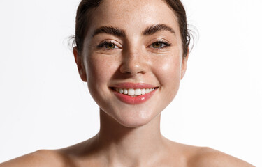 Spa and skin care. Smiling beautiful woman with thick eyebrows, nourished healthy face, showing...