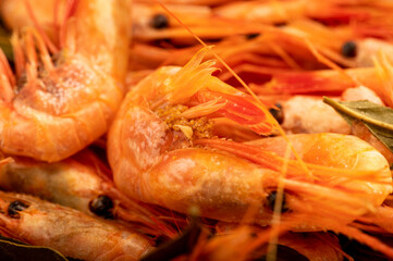 Atlantic shrimp cooked with allspice and bay leaf close-up, surface texture.