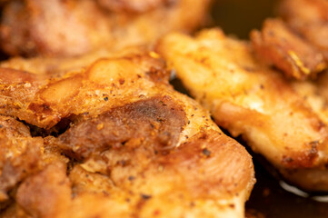 Fried pieces of meat in a frying pan, close-up, selective focus.
