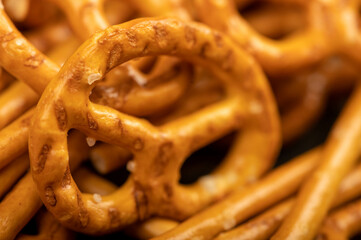 Crispy bread straws with salt, close-up, selective focus, top view.