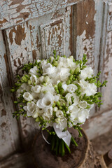 White freesia bridal bouquet on dark background. close up. Wedding bouquet.