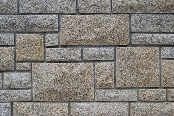 Textura de parede em pedras com cortes a direito em formas de quadrados e retângulos, pedaços de pedras encaixados, labirinto