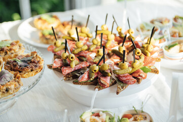 Buffet table of reception with cold snacks, meat and salads